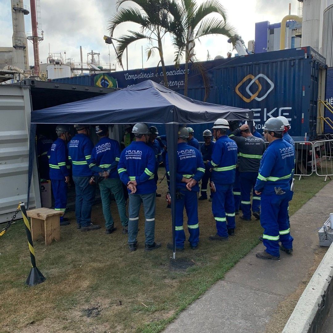 Equipe Futura reunida ao lado de um contêiner de obra